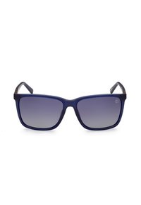 Gafas de sol con un marco mate azul marino y lentes oscuros en degradado. Forma cuadrada con patillas robustas y un sutil detalle de marca.
