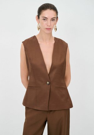 Bruine mouwloze blazer met een diepe V-hals, enkele knoopsluiting en twee voorkruiszakken. Gladde textuur, aansluitend ontwerp.
