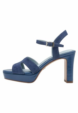 Blauwe platte sandalen met suède bovenwerk, open teen en verstelbare enkelriem. Structuurhak en glad, glanzend plateau.