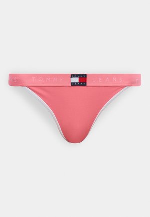 Pink low-rise bikini brief with Tommy Jeans logo patch centered on waistband and "Tommy Jeans" text repeated along waistband.