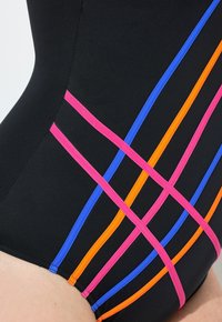 Černé plavky s diagonálními akcenty v růžové, modré, oranžové a fialové barvě. Hladká textura s přiléhavým designem.