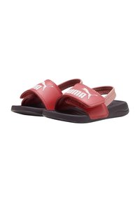 Rode synthetische slippers met een gestructureerde band, met een wit Puma-logo. De zool is zwart en ontworpen voor comfort.