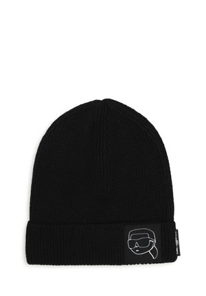 Bonnet noir en tricot avec un revers présentant un patch monochrome d’un visage stylisé portant des lunettes de soleil et un foulard.