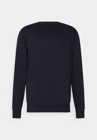 Granatowa bluza z miękkiego materiału, z długimi rękawami i okrągłym dekoltem. Prosty design z prążkowanymi mankietami i dołem.