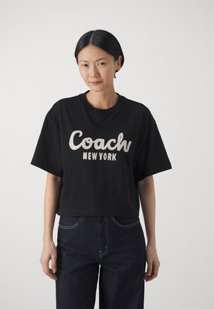 CURSIVE COACH CROPPED - Printtipaita - black