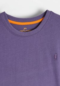 Fioletowy bawełniany T-shirt z prążkowanym okrągłym dekoltem, z pomarańczowym wewnętrznym kołnierzem i małym haftowanym logo na piersi.