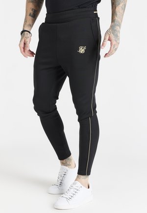 EXPOSED TAPE JOGGERS - Pantalones deportivos - black/gold