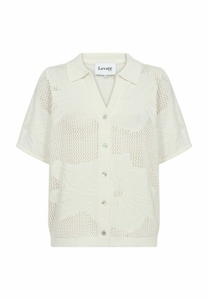 Vit stickad cardigan med korta ärmar, med krage och knäppning. Tyget har ett texturerat, öppet stickmönster.