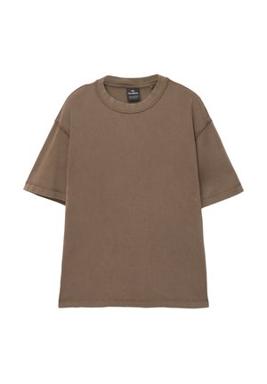 T-shirt brun surdimensionné en coton doux, avec un col rond, des manches courtes, et des détails de couture visibles sur l'ensemble.