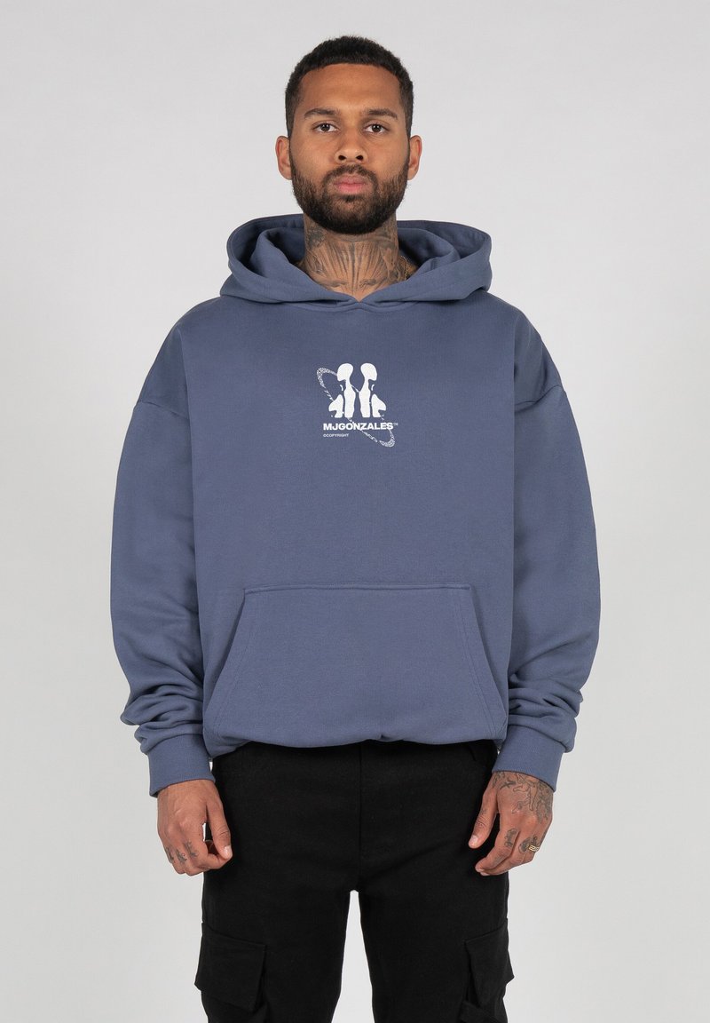 Hooded sweatshirt in navy blue cotton with a front pocket. Features a white graphic print logo at the chest. Ribbed cuffs and hem.