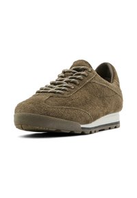 Brown suede sneaker with round toe, textured upper, gray laces, and a white midsole. Features a treaded rubber outsole for grip.