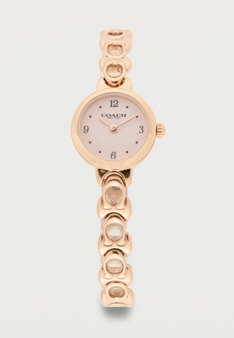Montre-bracelet Coach New York en or rose avec cadran rond rose, repères horaires minimalistes et bracelet à maillons.