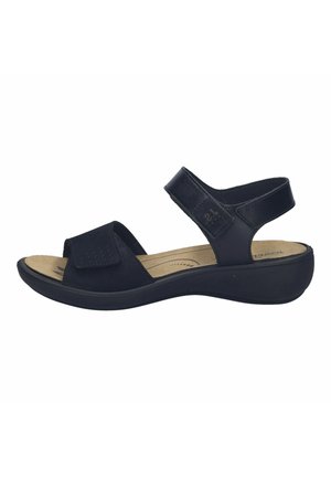 Black open-toe sandal with adjustable straps, cushioned beige insole, and low wedge heel for comfort and support.