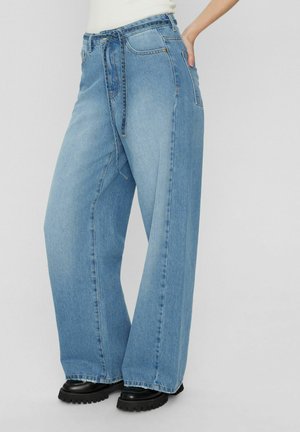 Light blue wide-leg jeans made of denim with a high waist, front pockets, and a tie belt. Features a clean cut and slightly frayed hem.