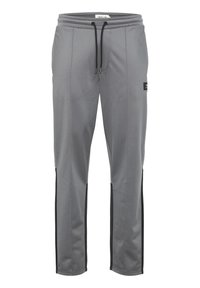 Pantalones deportivos grises de tejido suave, con paneles laterales negros, cintura elástica con cordón y diseño ajustado.