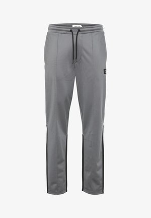 Hallid spordipüksid, mis on valmistatud siledast kangast, mustade külgpaneelidega, elastse vöökoha ja paelaga, ning kitseneva disainiga.