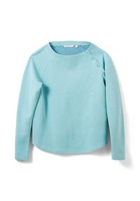 Light blue long-sleeve top made from a soft material. Features raglan sleeves and four snap buttons on the neckline for closure.