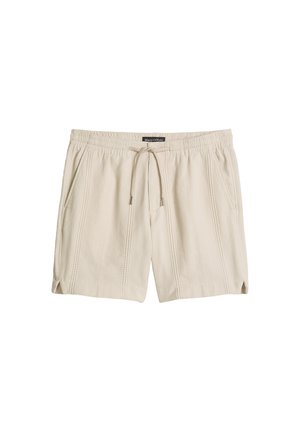 Beige legere Shorts mit elastischem Bund, Kordelzug, Seitentaschen, dezent vertikaler Struktur und kleinen Schlitzen an den Beinöffnungen.