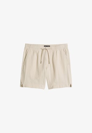 Beige legere Shorts mit elastischem Bund, Kordelzug, Seitentaschen, dezent vertikaler Struktur und kleinen Schlitzen an den Beinöffnungen.