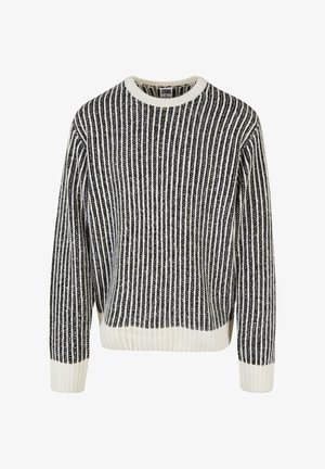Črno-bela prugasta pletena jopica z okroglim izrezom, rebrasto teksturo in dolgimi rokavi. Spodnji rob in manšete imajo enobarvne bele poudarke.