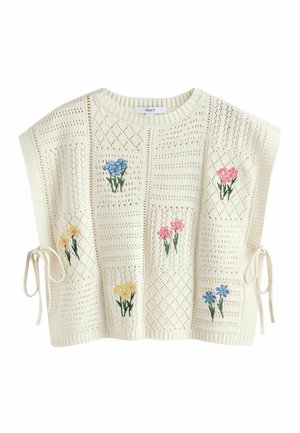 Krémový pletený svetřík bez rukávů s diamantovým vzorem, bočními šňůrkami a vyšívanými shluky růžových, modrých a žlutých květin na předních dílech.
