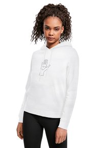 Vit hoodie med en framficka i kängurustil, pryd med en grafik av en hand med ett hjärta. Finns med dragsnören och ribbade muddar.