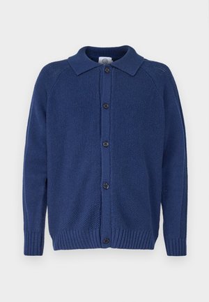 Strikket marineblå cardigan med krage, knappelukking, ribbestrikkede mansjetter og fald, med teksturert stoff og raglanermer.