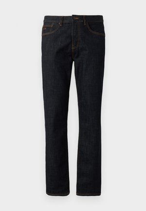 Temno modri skinny jeans z oranžnim šivom, zapiranjem na gumb in zasnovo s petimi žepi, prikazani na ravni površini na belem ozadju.
