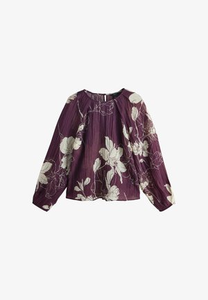 Violeta ziedu blūze ar garām ievilktām piedurknēm. Audums ar tekstūru un baltu ziedu rakstu, apaļa kakla izgriezuma. Aizmugurē atvērums ar pogu.