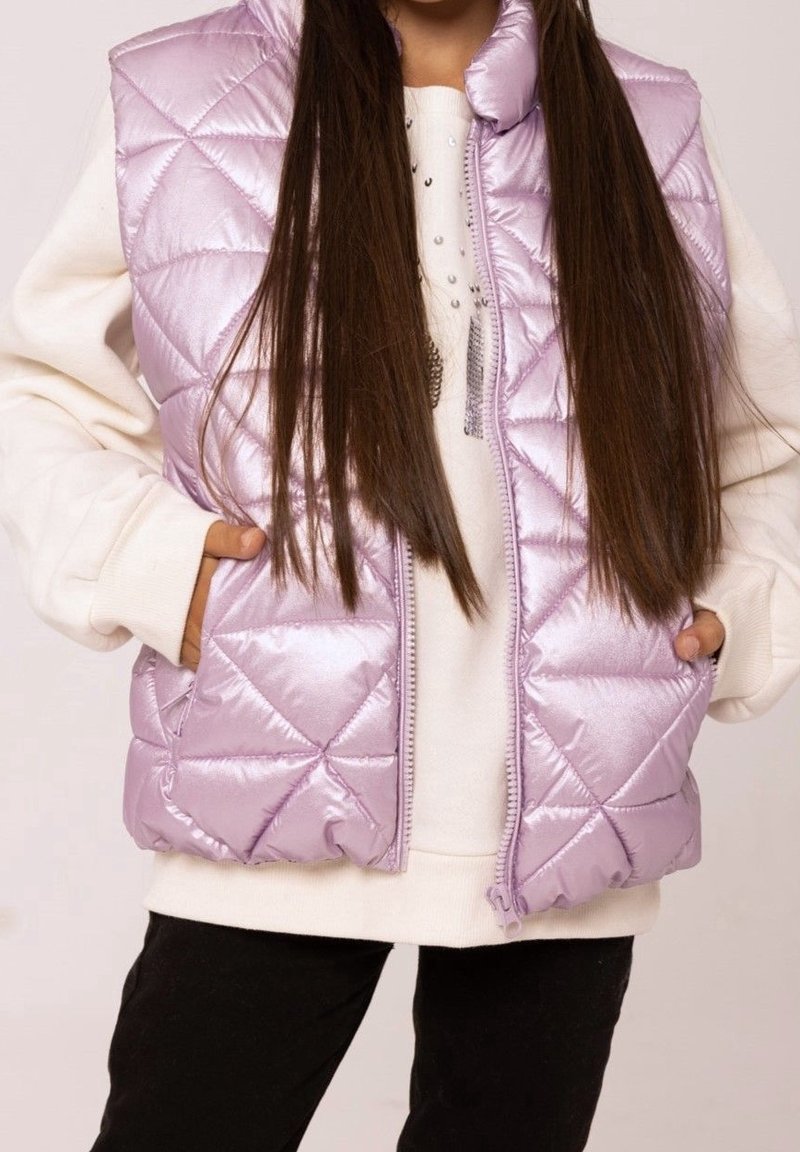 Lila gesteppte Pufferweste mit glänzender, glatter Textur, verfügt über einen hohen Kragen, einen Reißverschluss und Seitentaschen, getragen über einem cremefarbenen Sweatshirt.