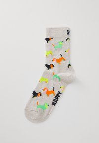 Baumwollsocken mit einem hellgrauen Grundton, die mit bunten Hundemustern in Neonpink, -grün, -orange und Schwarz verziert sind. Der Text an der Seite lautet "HAPPY."