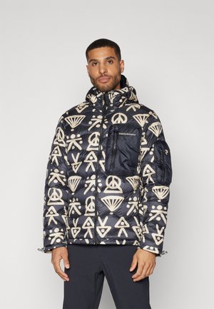 Chaqueta acolchada en negro con patrones geométricos en crema, con capucha, cierre de cremallera y un bolsillo en el pecho con detalle del logo.