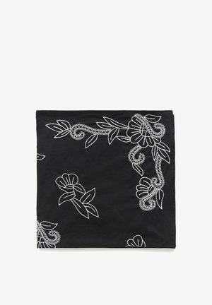 Black fabric square with white floral embroidery featuring flowers, leaves, and swirling vine patterns along the edges and center.