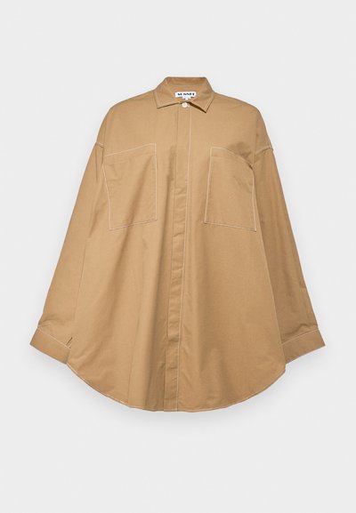 Light brown long-sleeve shirt made of smooth fabric, featuring a buttoned collar, two front pockets, and contrasting white stitching.