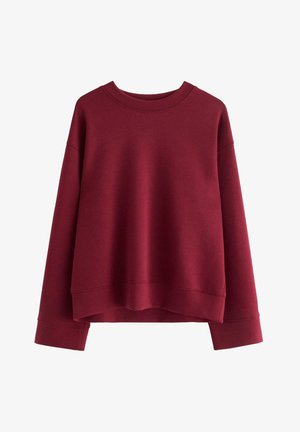 Burgundin värinen ylisuuri collegepaita, joka on valmistettu pehmeästä puuvillasekoitteesta. Ominaisuuksiin kuuluu pyöreä kaula-aukko, alaslasketut olkapäät ja ribbireunat.