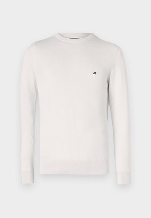Witte gebreide trui met een ronde hals en lange mouwen. Heeft een klein logo in rood en blauw op de linkerkant van de borst. Zachte textuur.