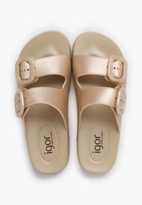 Brown vegan leather slide sandals with two adjustable straps, smooth texture, and textured footbed. Logo printed on inner sole.