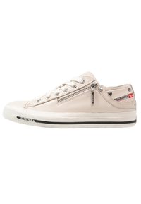 Sneakers in pelle beige chiaro con lacci bianchi, dettagli con zip laterale e striscia nera lungo la suola. Presentano un piccolo logo laterale.