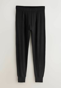 Čierne legíny s hladkou textúrou, vybavené elastickým pásom a predným otvorom. Lemovanie na členkoch pre priliehavý štýl.