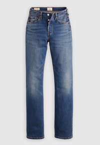 Jean en denim bleu à coupe droite, cinq poches et fermeture par boutons, présenté sur un fond blanc uni.