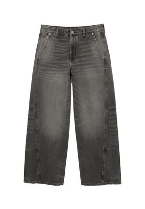 Wide-leg jeans in faded black denim, featuring a textured finish, four pockets, and visible stitching. Patch accents on the sides.