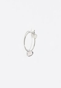Pendiente de aro de plata que presenta dos charms en forma de corazón, uno liso y otro texturizado, con un acabado pulido. El diseño circular realza su versatilidad.