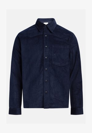 Chemise en velours côtelé marine avec un col pointu, des manches longues, une poche poitrine, un devant boutonné et une texture côtelée.
