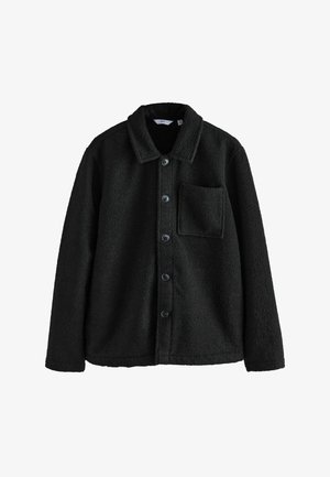 Must tumesärk paeltega, millel on krae, esimesed nupud ja üks rinnatasku. Pehme tekstuur ja soe tunne. Sobib kihtidega riietumiseks.