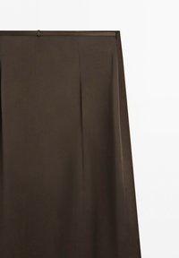 Dark brown straight skirt with belt loops and soft pleats against a plain white background.