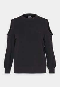 Sudadera negra con diseño de hombro descubierto, puños y dobladillo acanalados. Logo bordado en el pecho. Textura de tela suave y lisa.