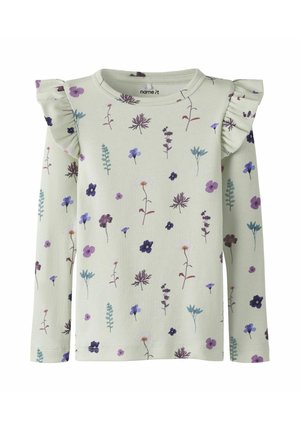 Cremefarbenes Langarmshirt mit lila und blauem Blumenmuster, mit gerafften Stoffdetails an den Schultern.