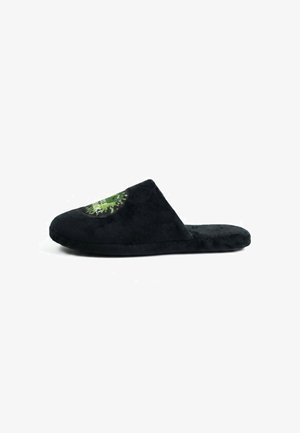 Black plush slip-on slipper with closed toe and green circular graphic on top, displayed on a white background, side view.