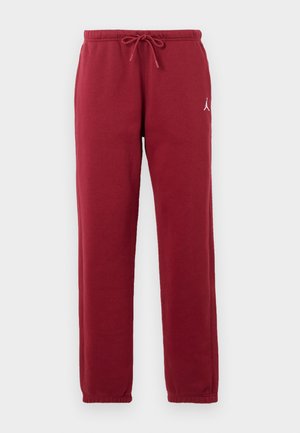 Pantalon de survêtement bordeaux avec taille élastique et cordon de serrage, poignets élastiques, et petit logo blanc sur la cuisse gauche.