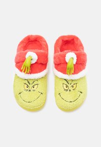 Green Grinch-themed slippers with a fuzzy yellow body, red fuzzy band, white trim, and green hand accent, featuring a printed face.